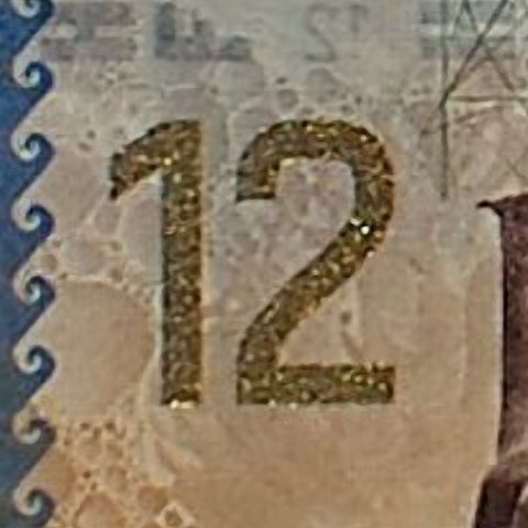 The numeral 12 printed in optically variable ink